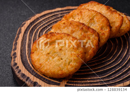 Potato hash browns, a meal with onions, cabbage in the form of fritters 128839134