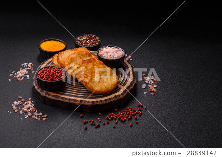 Potato hash browns, a meal with onions, cabbage in the form of fritters 128839142