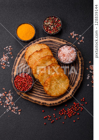 Potato hash browns, a meal with onions, cabbage in the form of fritters 128839144