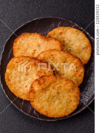 Potato hash browns, a meal with onions, cabbage in the form of fritters Potato hash browns, a meal with onions, cabbage in the form of fritters 128839152