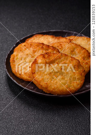 Potato hash browns, a meal with onions, cabbage in the form of fritters Potato hash browns, a meal with onions, cabbage in the form of fritters 128839153