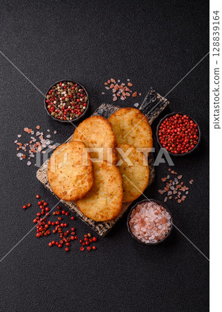 Potato hash browns, a meal with onions, cabbage in the form of fritters 128839164