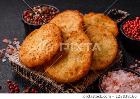 Potato hash browns, a meal with onions, cabbage in the form of fritters 128839166