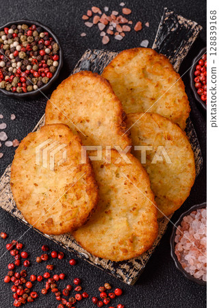 Potato hash browns, a meal with onions, cabbage in the form of fritters 128839168