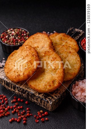 Potato hash browns, a meal with onions, cabbage in the form of fritters Potato hash browns, a meal with onions, cabbage in the form of fritters 128839169