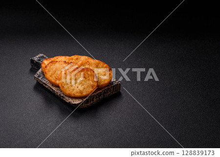 Potato hash browns, a meal with onions, cabbage in the form of fritters 128839173