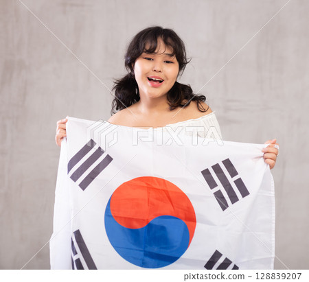 Smiling young girl holding South Korea flag 128839207