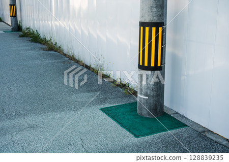 A signboard on a utility pole installed on the road in front of the construction site A signboard on a utility pole installed on the road in front of the construction site 128839235