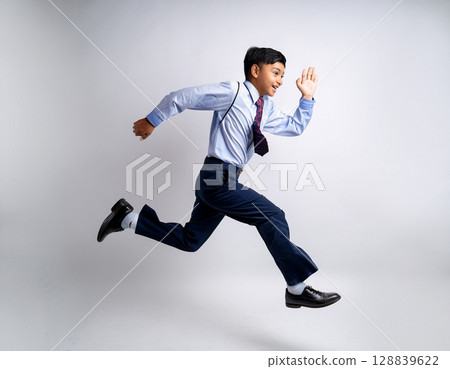 Young male junior high school student running in uniform Young male junior high school student running in uniform 128839622