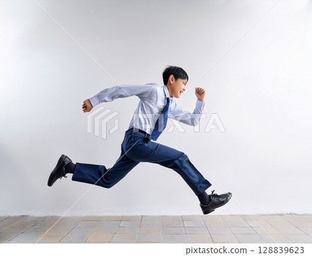 Young male junior high school student running in uniform 128839623