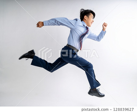 Young male junior high school student running in uniform 128839627