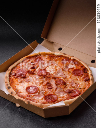 Italian pepperoni pizza with cheese and salami, tomatoes and sauce Italian pepperoni pizza with cheese and salami, tomatoes and sauce 128839659