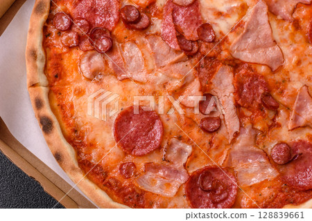 Italian pepperoni pizza with cheese and salami, tomatoes and sauce Italian pepperoni pizza with cheese and salami, tomatoes and sauce 128839661