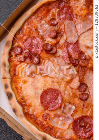 Italian pepperoni pizza with cheese and salami, tomatoes and sauce Italian pepperoni pizza with cheese and salami, tomatoes and sauce 128839662