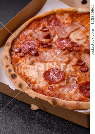 Italian pepperoni pizza with cheese and salami, tomatoes and sauce Italian pepperoni pizza with cheese and salami, tomatoes and sauce 128839663