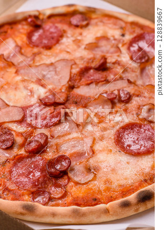 Italian pepperoni pizza with cheese and salami, tomatoes and sauce Italian pepperoni pizza with cheese and salami, tomatoes and sauce 128839667