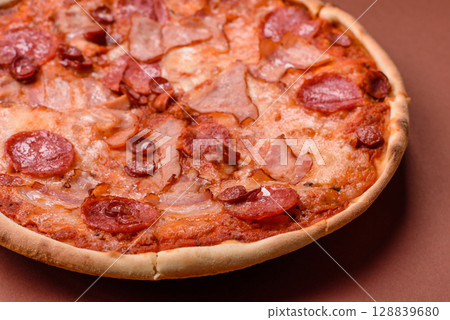 Italian pepperoni pizza with cheese and salami, tomatoes and sauce Italian pepperoni pizza with cheese and salami, tomatoes and sauce 128839680