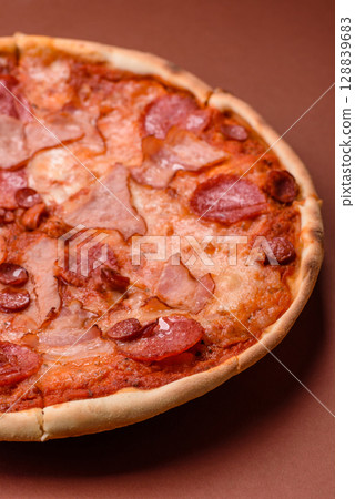 Italian pepperoni pizza with cheese and salami, tomatoes and sauce 128839683