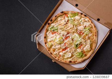 Italian caesar pizza with cheese and chicken, lettuce leaves and sauce 128839687