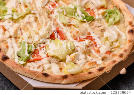 Italian caesar pizza with cheese and chicken, lettuce leaves and sauce 128839694