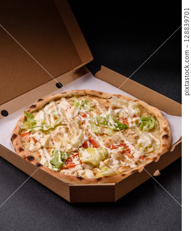 Italian caesar pizza with cheese and chicken, lettuce leaves and sauce Italian caesar pizza with cheese and chicken, lettuce leaves and sauce 128839701
