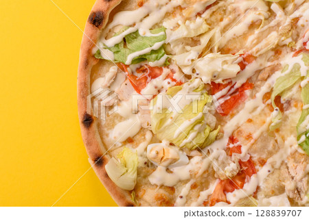 Italian caesar pizza with cheese and chicken, lettuce leaves and sauce 128839707