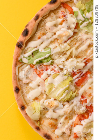 Italian caesar pizza with cheese and chicken, lettuce leaves and sauce Italian caesar pizza with cheese and chicken, lettuce leaves and sauce 128839708