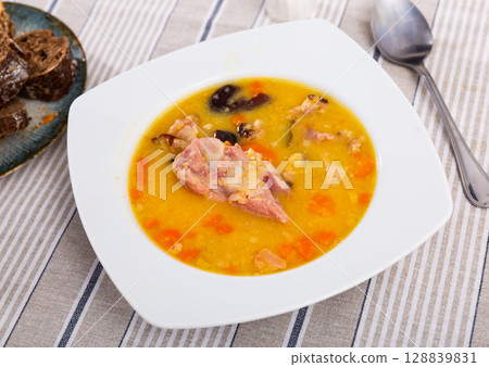 Hot pea soup with smoked meats and vegetables Hot pea soup with smoked meats and vegetables 128839831