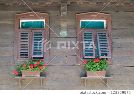 Windows on typical wooden house in the village Krapje, Lonjsko Polje Nature park, Croatia Windows on typical wooden house in the village Krapje, Lonjsko Polje Nature park, Croatia 128839973