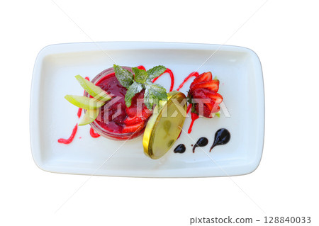 Delicious panna cotta with strawberry coulis and fresh berries on wooden background 128840033