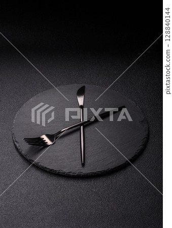 Empty plate with devices in the form of clock hands as a conceptual background for lunch time Empty plate with devices in the form of clock hands as a conceptual background for lunch time 128840144