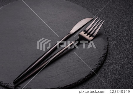 Empty plate with utensils as a conceptual background for lunch, breakfast, meal Empty plate with utensils as a conceptual background for lunch, breakfast, meal 128840149