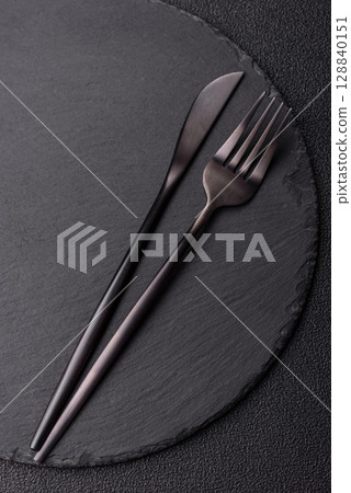 Empty plate with utensils as a conceptual background for lunch, breakfast, meal Empty plate with utensils as a conceptual background for lunch, breakfast, meal 128840151