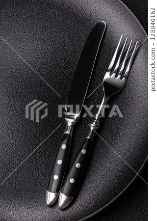 Empty plate with utensils as a conceptual background for lunch, breakfast, meal Empty plate with utensils as a conceptual background for lunch, breakfast, meal 128840162