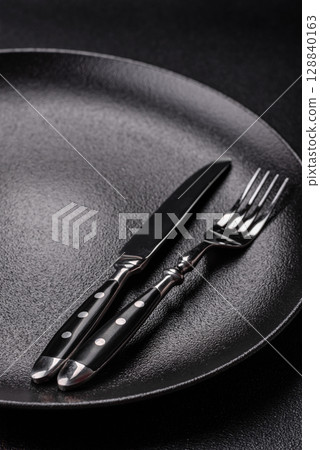 Empty plate with utensils as a conceptual background for lunch, breakfast, meal 128840163