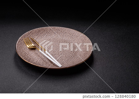 Empty plate with utensils as a conceptual background for lunch, breakfast, meal Empty plate with utensils as a conceptual background for lunch, breakfast, meal 128840180