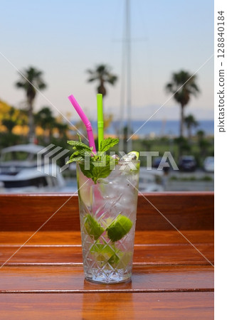 mojito cocktail on the beach. Close-up mojito cocktail at the bar. Mojito cocktail with mint lime. mojito cocktail on the beach. Close-up mojito cocktail at the bar. Mojito cocktail with mint lime. 128840184