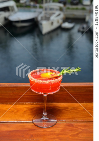 Margarita cocktail with lime, tequila, mint and ice on dark table with amazing backlight, copy space. Classic Margarita 128840196