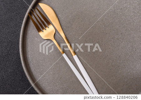 Empty plate with utensils as a conceptual background for lunch, breakfast, meal Empty plate with utensils as a conceptual background for lunch, breakfast, meal 128840206