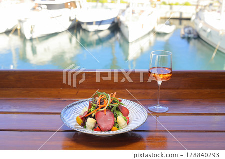 Seasonal Salad with Homemade Pastrami or bacon. With blush or rose wine. 128840293