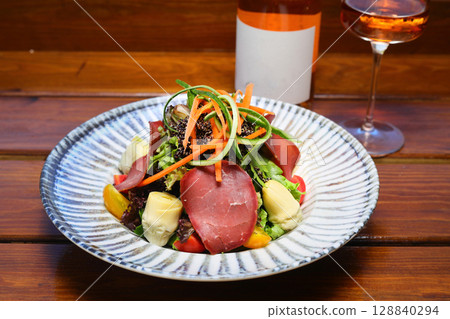 Seasonal Salad with Homemade Pastrami or bacon. With blush or rose wine. 128840294