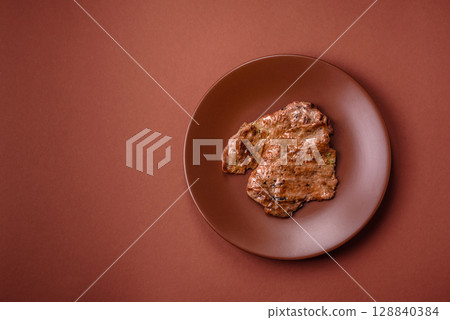 Steak, grilled beef, sirloin cooked on the barbecue with salt and spices 128840384
