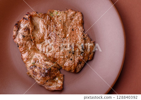 Steak, grilled beef, sirloin cooked on the barbecue with salt and spices 128840392