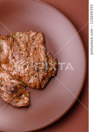 Steak, grilled beef, sirloin cooked on the barbecue with salt and spices Steak, grilled beef, sirloin cooked on the barbecue with salt and spices 128840393