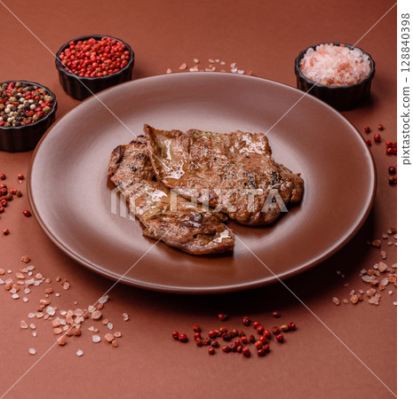 Steak, grilled beef, sirloin cooked on the barbecue with salt and spices 128840398