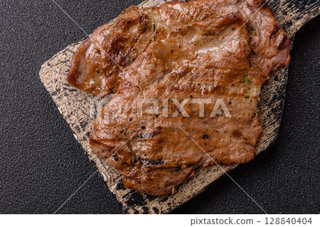 Steak, grilled beef, sirloin cooked on the barbecue with salt and spices 128840404