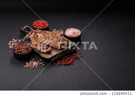 Steak, grilled beef, sirloin cooked on the barbecue with salt and spices Steak, grilled beef, sirloin cooked on the barbecue with salt and spices 128840411