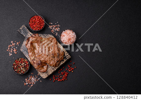 Steak, grilled beef, sirloin cooked on the barbecue with salt and spices 128840412