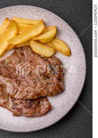 Steak, grilled beef, sirloin cooked on the barbecue with salt and spices Steak, grilled beef, sirloin cooked on the barbecue with salt and spices 128840425