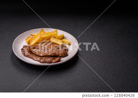 Steak, grilled beef, sirloin cooked on the barbecue with salt and spices 128840426